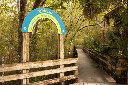 Welcome Sign at Six Mile Cypress Slough Preserve With Boardwalk Leading Into Wetland Area in Fort Myers Florida