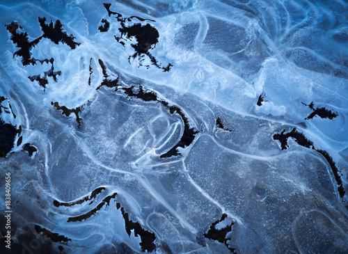 winter background shapes on frozen water surface