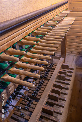 Players perspective: close-up of wooden levers, pedals and internal mechanics. The instrument controls giant bells - demanding strength, precision, and tradition.