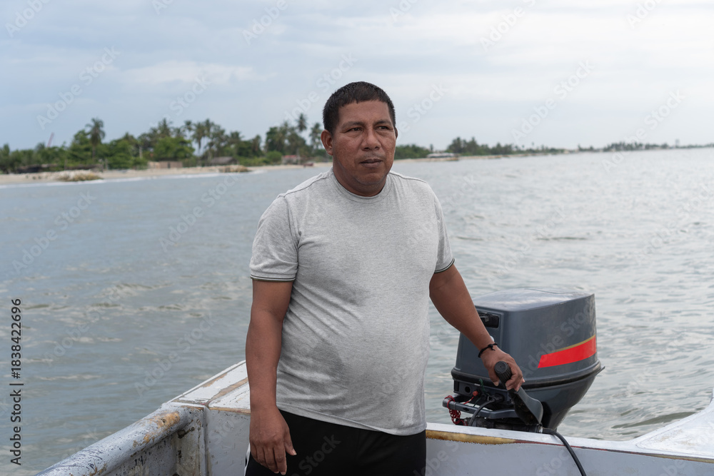 Fototapeta premium Man driving boat with outboard motor on tropical coast