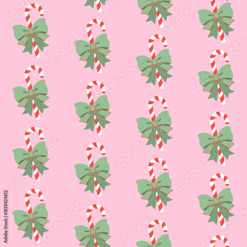 Bożonarodzeniowe cukrowe laski z piękną zieloną kokardą na różowym tle. Świąteczny bezszwowy wzór wektorowy.