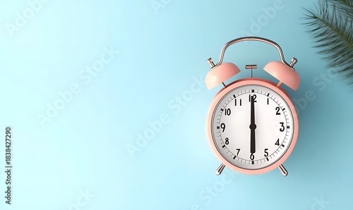 Alarm clock showing six o clock on blue background with a leaf branch decor