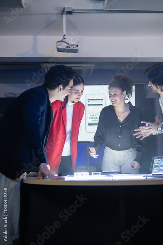 Diverse front-end developer and UX UI design team in a professional discussion over a complex web development project. Collaborating on the visual design and application strategy,