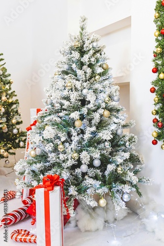 Festive Christmas tree decorated with ornaments and presents for the winter holiday season celebration