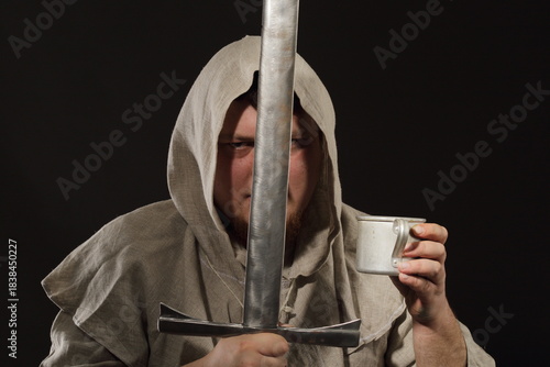 A menacing warrior monk with a sword in one hand and a mug filled with elixir or just moonshine in the other hand
