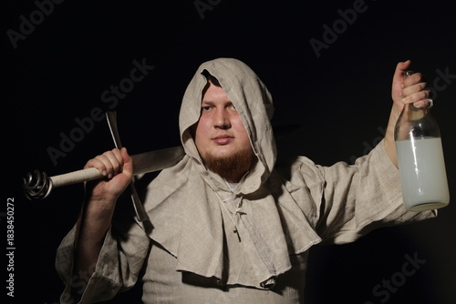 A menacing warrior monk with a sword in one hand and a bottle filled with elixir or just moonshine in the other hand