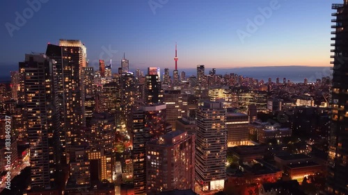 Drone view of the evening Toronto skyline. City lights. Downtown skyscrapers viewed from above. Toronto, Ontario, Canada.