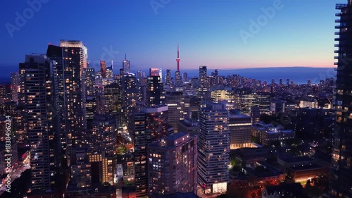 Drone view of the evening Toronto skyline. City lights. Downtown skyscrapers viewed from above. Toronto, Ontario, Canada.