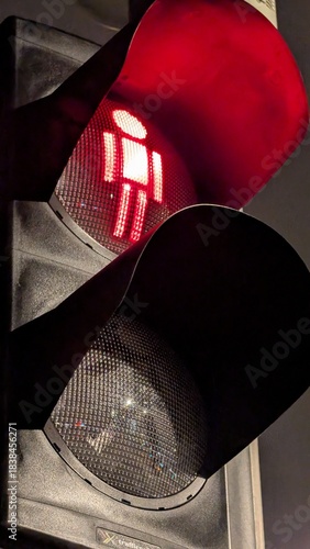 Pedestrian Stop Signal Glowing Red in Darkness