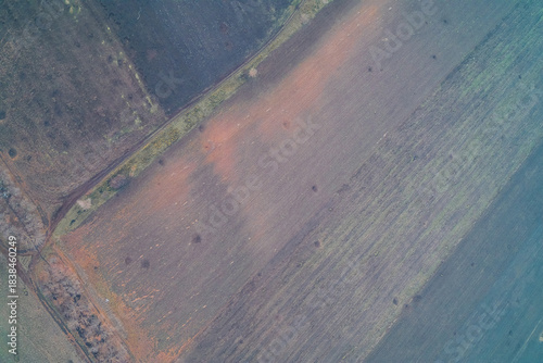 Tableau sur toile Aerial top down view of agricultural fields scarred by artillery craters and fire marks
