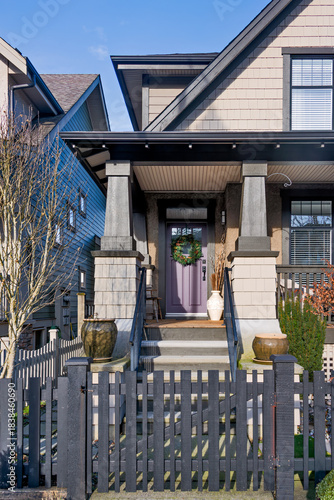 Residential house entrantrance with purple door decorated for Christmas season