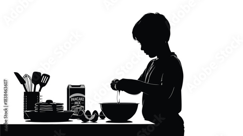 A silhouetted young boy is intently focused on mixing ingredients in a kitchen setting