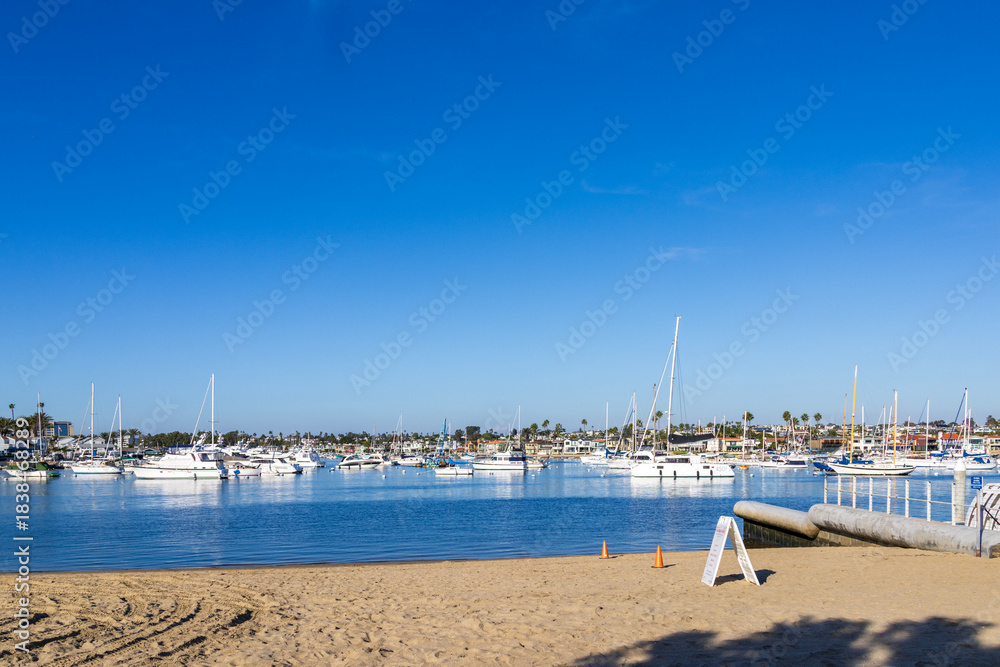 Obraz premium Boats and yachts docked on the Newport Bay at Marina Park in Newport Beach California USA