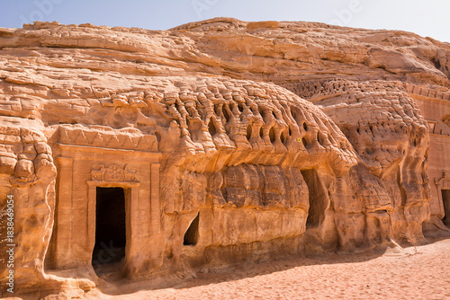 Portal of Nabataean rock cut tombs carved into the mountain face at the Hegra site in Saudi Arabia