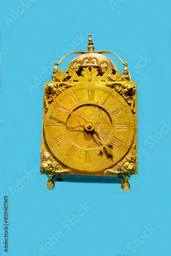 Antique alfalfa clock isolated on a blue background. Items watches antiques technologies World tourism.