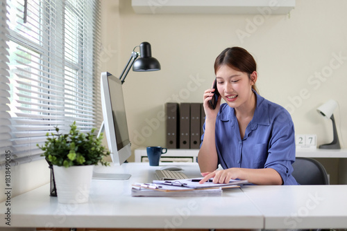 A woman is contacting a client via phone.