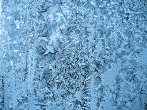 Beautiful ice patterns on window glass, close-up