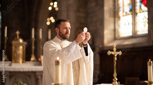 Catholic priest elevating communion host during Eucharistic consecration at altar, solemn mass in traditional church interior with candles and crucifix, sacred moment of Holy Communion and worship
