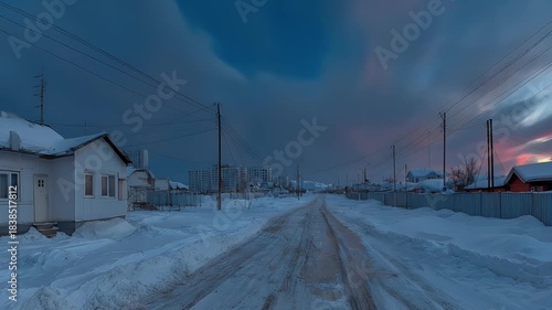 Winter Village Road Under Dramatic Sunset Sky.