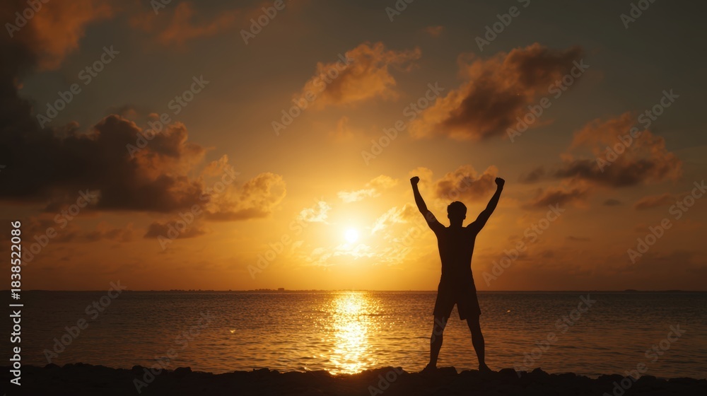 Fototapeta premium Silhouette of Athlete Celebrating Victory at Sunrise by the Sea