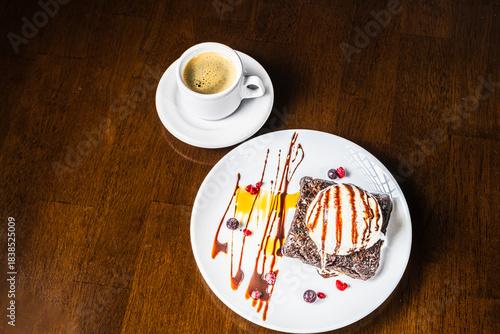 Aerial view of brownie with chocolate, coffee, red berries and ice cream.