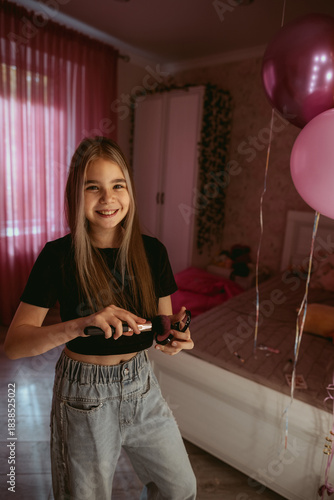 A teenage girl makes up near the mirror 