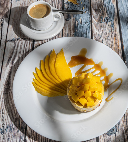Mango cake with chocolate, accompanied by a coffee.