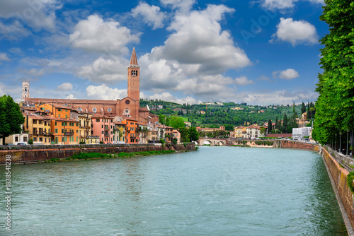 Fototapeta Naklejka Na Ścianę i Meble -  View of Adige river embankment and Basilica of Santa Anastasia in Verona, Italy. Architecture and landmarks of Verona. Cozy cityscape of Verona.