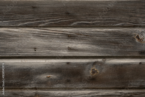 Detailed close-up of dark weathered wood texture with rustic horizontal planks and natural grain.