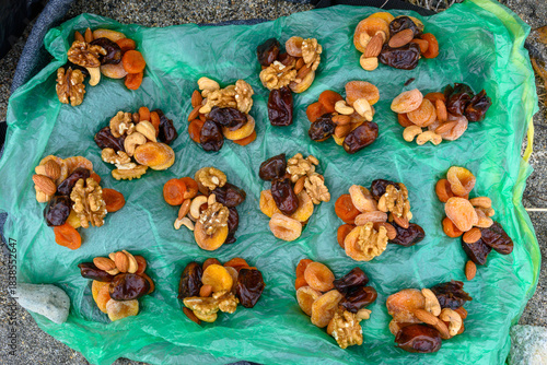 Canvastavla Dried fruits and nuts displayed on a green cloth in Russia's market