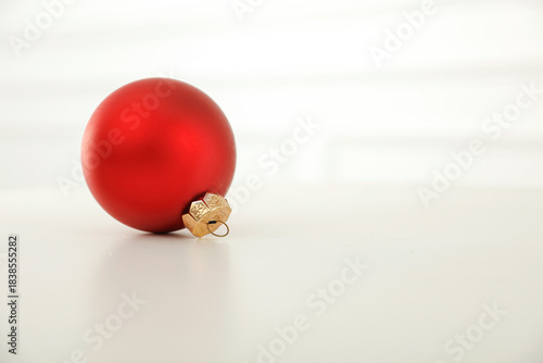 Minimalist holiday composition with elegant Christmas baubles on bright, clean background. Simple, modern festive winter decor, holiday and New Year themes. Copy space for text or product placement.
