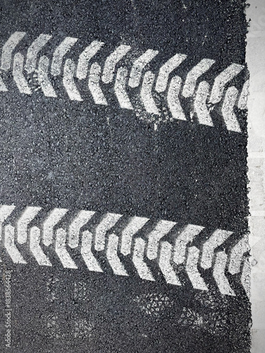 asphalt road texture with white painted car tired imprint