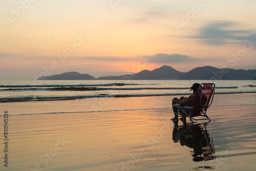 Man Relaxing on the Beach at Sunset in Santos, Brazil