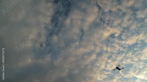 Drone quickly flies from top left to bottom right across sky