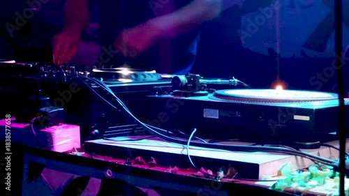 DJ Mixing Live on Stage with Turntables and Audio Gear