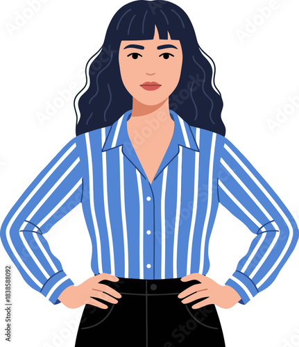 Portrait of a confident young woman with dark wavy hair wearing a blue-striped shirt and standing with hands on hips on a black background