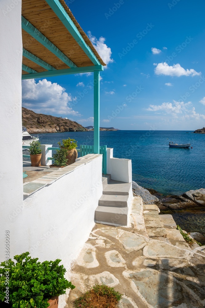 Obraz premium View down a typical traditional alleyway out to the sea in the rustic sugar cube village of Faros on the greek island of Sifnos.