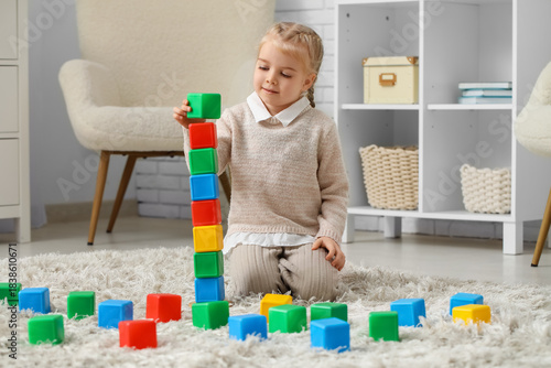 Cute little girl playing wi...