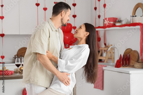Young couple dancing in kit...