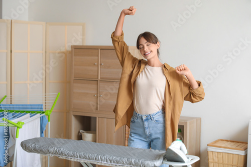 Happy young woman dancing i...