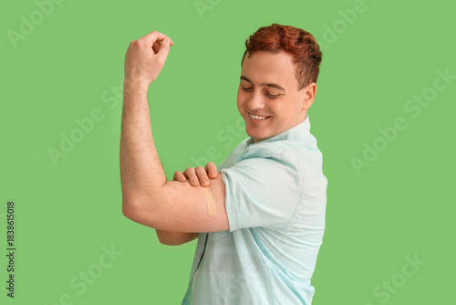 Young man showing arm with ...