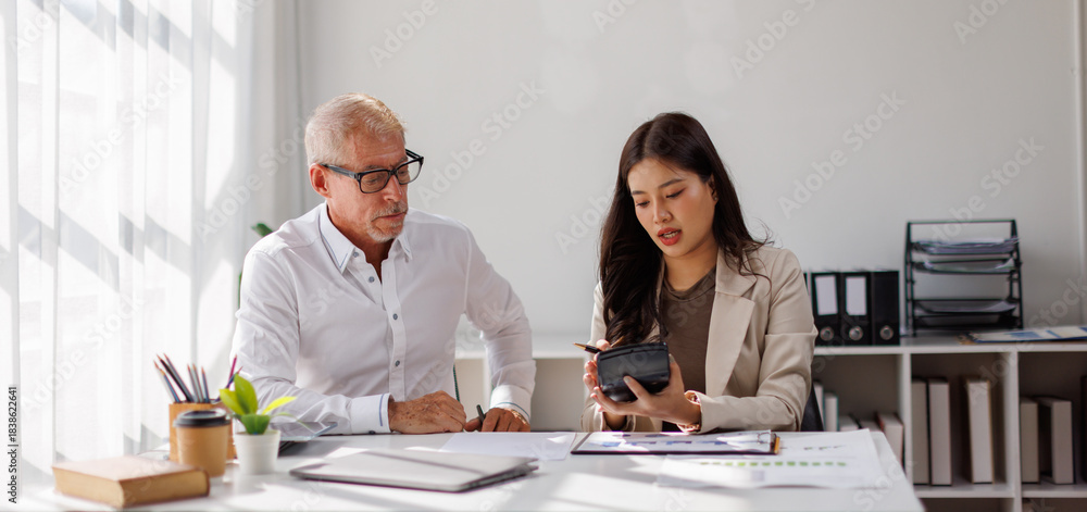 Obraz premium Team of business using calculator and laptop for do math finance on wooden desk in office and business working background, tax, accounting, statistics and analytical research concept 