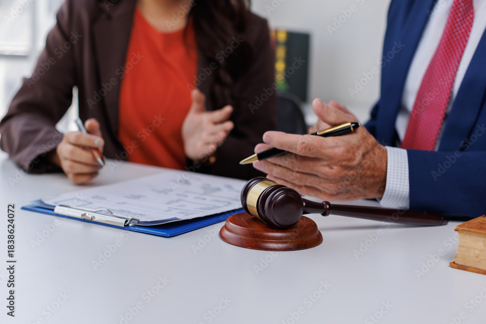 Fototapeta premium Business and lawyer discuss the contract document. Treaty of the law. Sign a contract business at the lawyer, lawyer meeting concept. 