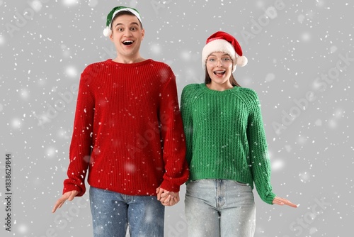 Surprised couple in warm sw...