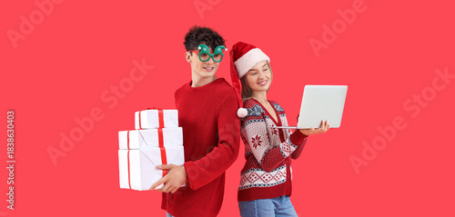 Happy young couple with lap...