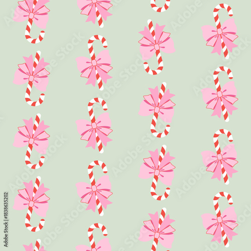 Bożonarodzeniowe cukrowe laski z piękną różową kokardą na jasnym zielonym tle. Świąteczny bezszwowy wzór wektorowy.