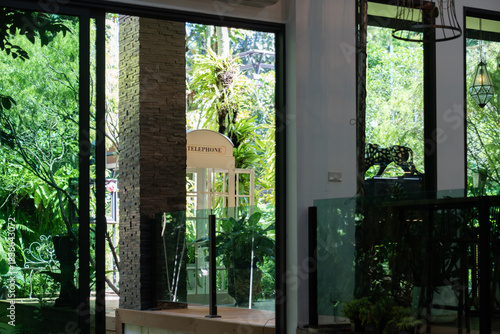 Wallpaper Mural A classic white telephone booth stands quietly among lush greenery, giving a charming nostalgic feel. The rotary phone decorate in the coffee cafe. Torontodigital.ca