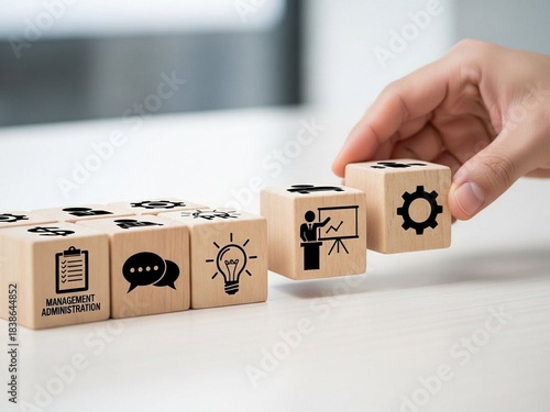 a professional hand arranging wooden blocks on a table