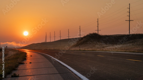 foggy sunrise over a highway in Nebraska Sandhills near Mullen
