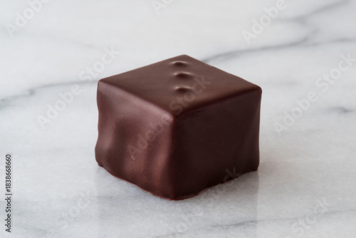 Assortment of chocolates lined up on a white background
